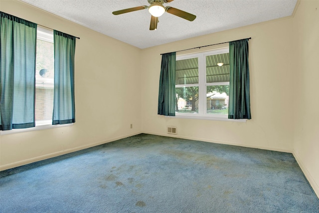 spare room featuring carpet flooring, a textured ceiling, and ceiling fan