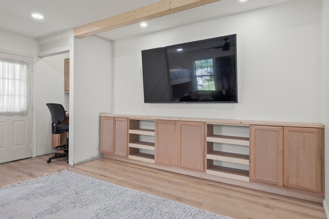 unfurnished office featuring light hardwood / wood-style flooring and beamed ceiling