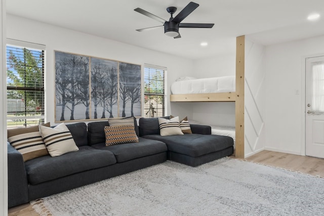 living room with ceiling fan and light hardwood / wood-style floors