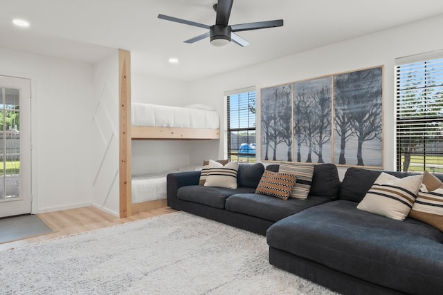 living room with ceiling fan, plenty of natural light, and hardwood / wood-style floors