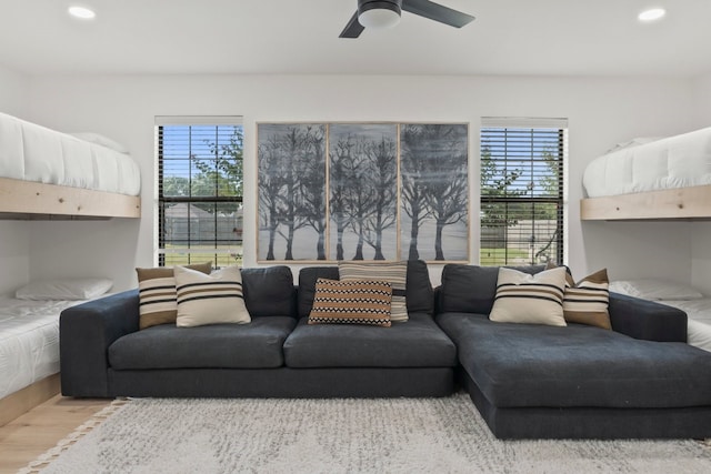 living room featuring ceiling fan, a healthy amount of sunlight, and light hardwood / wood-style flooring