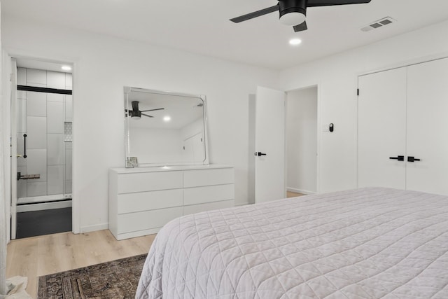 bedroom with ceiling fan, a closet, ensuite bathroom, and light hardwood / wood-style floors