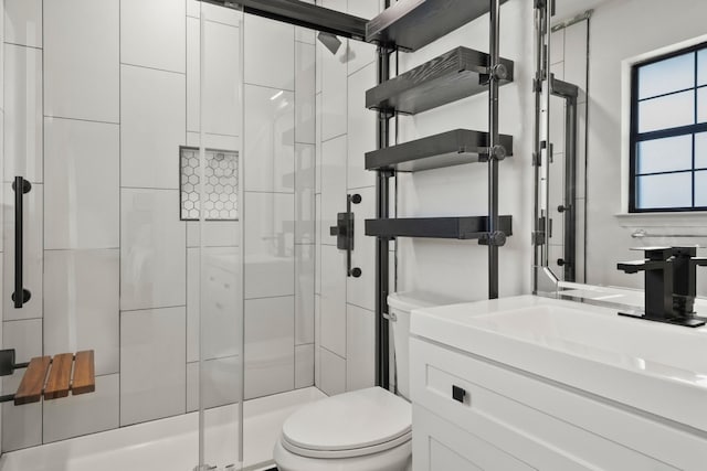 bathroom with toilet, vanity, and walk in shower