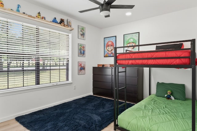 bedroom with ceiling fan and hardwood / wood-style floors