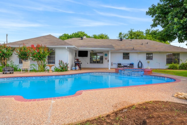 view of swimming pool featuring ceiling fan, a patio area, and an in ground hot tub