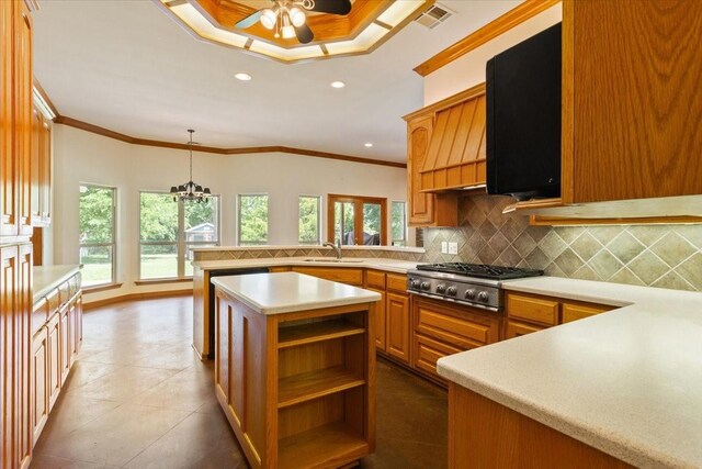 kitchen with ceiling fan with notable chandelier, tile patterned floors, backsplash, and ornamental molding