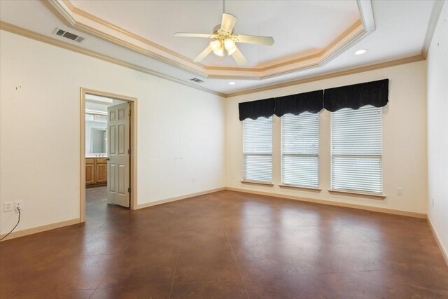 unfurnished room with ceiling fan, ornamental molding, and a tray ceiling