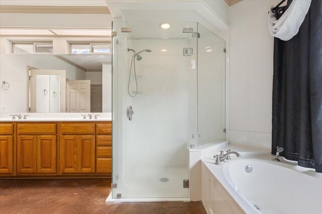 bathroom with double vanity, tile patterned flooring, plus walk in shower, and ornamental molding