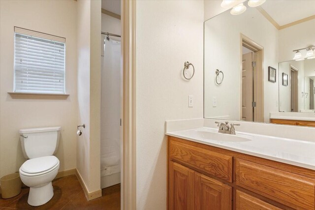 bathroom featuring vanity, toilet, tile patterned flooring, and crown molding