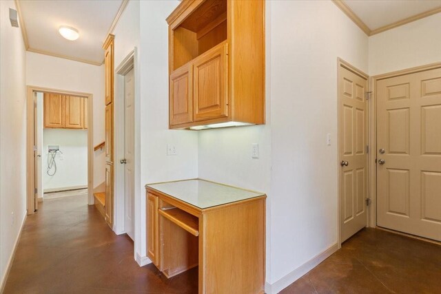 corridor featuring ornamental molding and dark tile patterned flooring