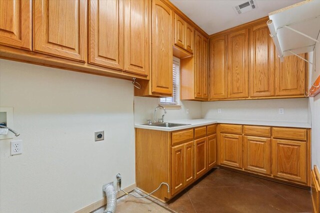 kitchen featuring sink and dark tile patterned floors