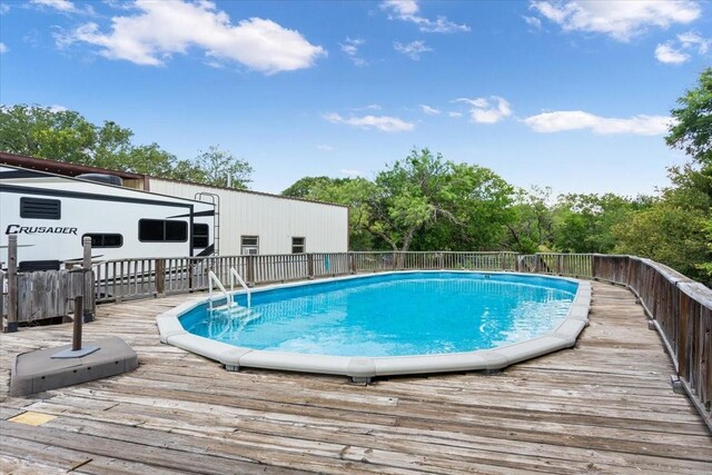 view of swimming pool featuring a wooden deck