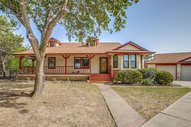 view of front facade with a garage, a front yard, and a porch