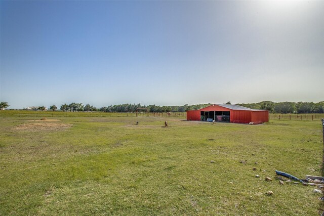 view of yard featuring a rural view and an outdoor structure