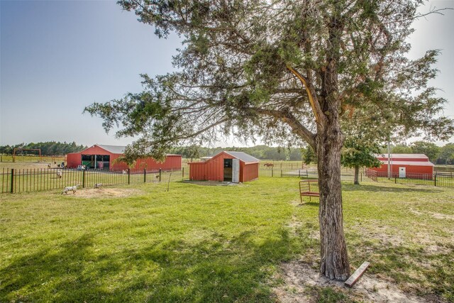 view of yard with a rural view and an outdoor structure