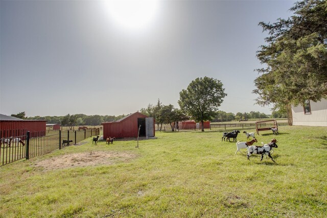 view of yard featuring a rural view and an outdoor structure