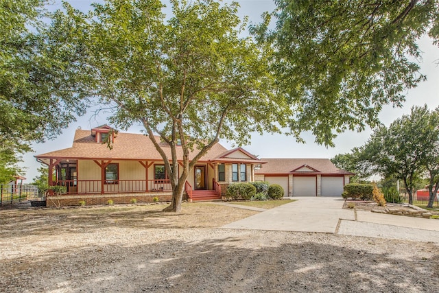 ranch-style home with a garage and a porch