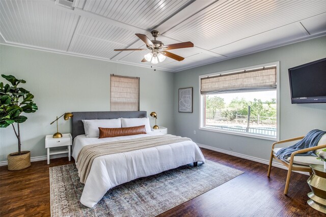 bedroom with ceiling fan, ornamental molding, and dark hardwood / wood-style floors