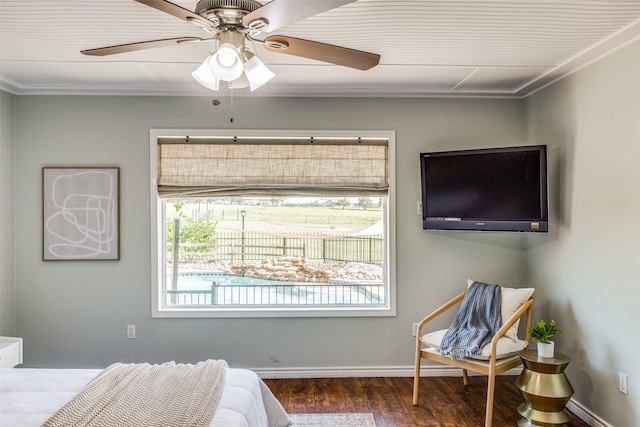 bedroom featuring dark wood-type flooring, ceiling fan, and crown molding