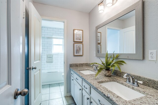 full bathroom with toilet, vanity, tiled shower / bath, and tile patterned flooring