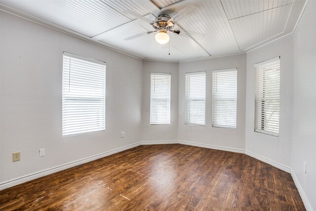 unfurnished room featuring dark wood-type flooring, ceiling fan, and ornamental molding