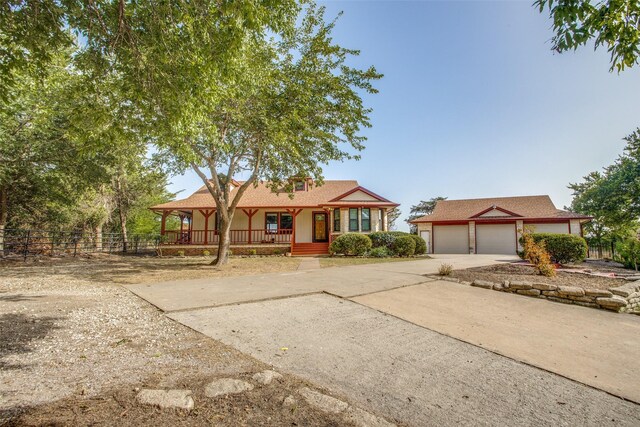 view of front of property featuring covered porch and a garage