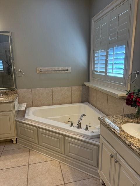 bathroom with vanity, tile patterned flooring, and a bathtub