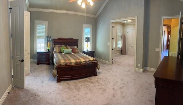 carpeted bedroom with vaulted ceiling, ornamental molding, and ceiling fan