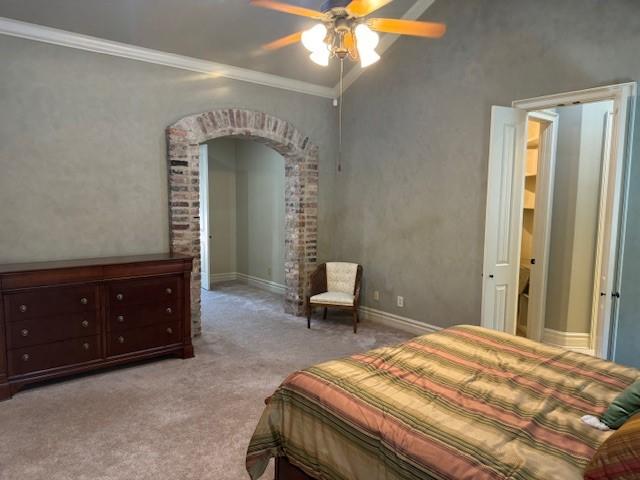 carpeted bedroom featuring crown molding and ceiling fan