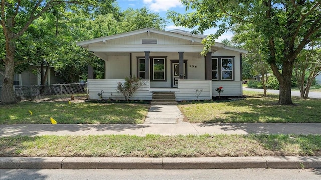 bungalow-style home featuring a porch and a front lawn