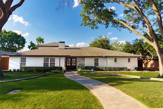 ranch-style home with a front lawn