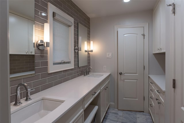 bathroom with vanity and tasteful backsplash