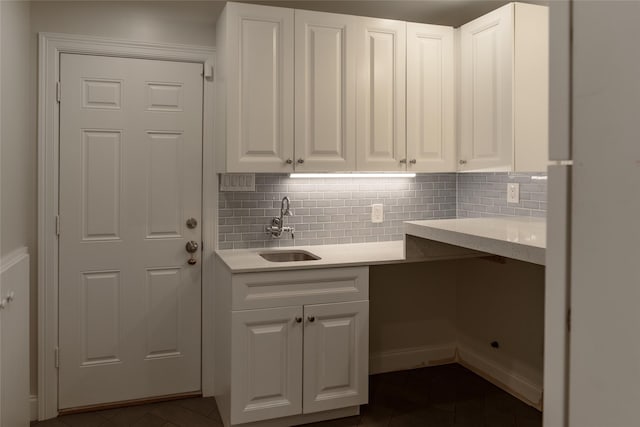 laundry area with sink and dark tile patterned flooring