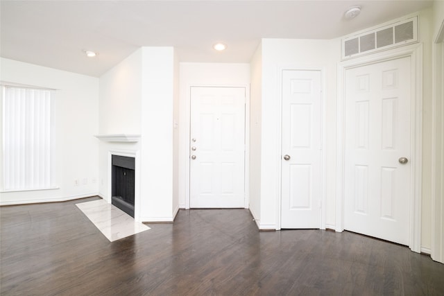 unfurnished living room with dark wood-type flooring