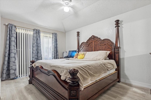 bedroom featuring a textured ceiling, ceiling fan, and light hardwood / wood-style flooring