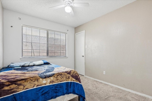 carpeted bedroom with a textured ceiling and ceiling fan