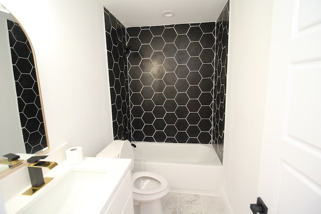 full bathroom featuring tiled shower / bath, vanity, and toilet