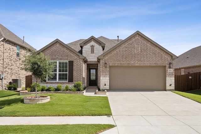 view of front of home with central AC unit, a front yard, and a garage