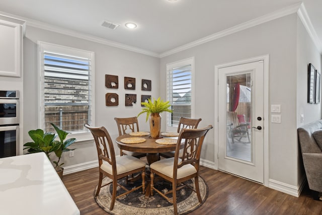 dining area featuring dark hardwood / wood-style flooring, plenty of natural light, and ornamental molding