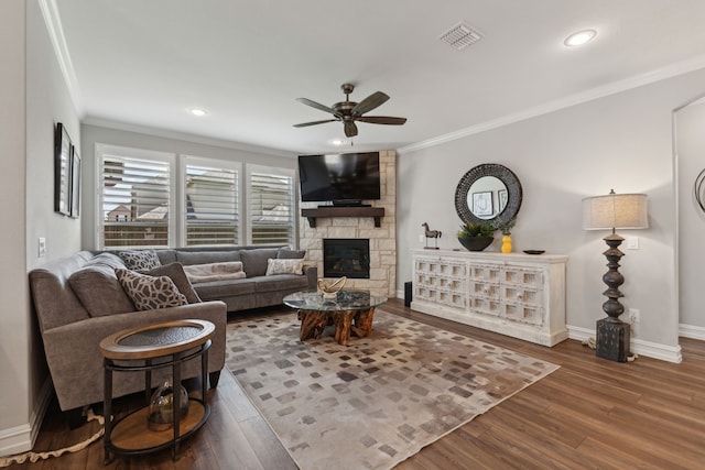 living room with ceiling fan, a fireplace, dark hardwood / wood-style floors, and ornamental molding