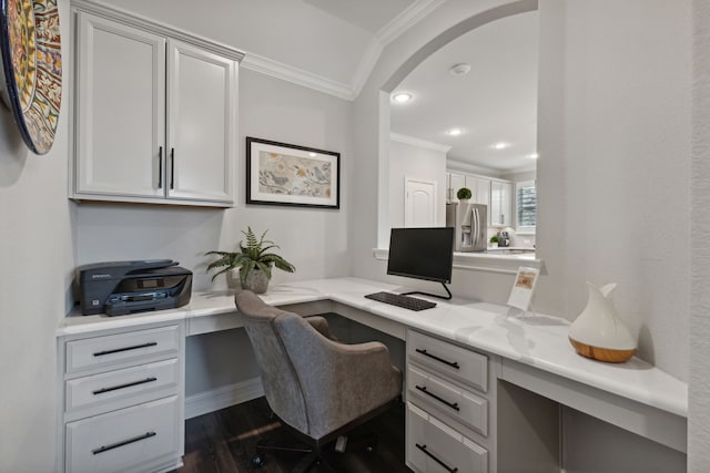 home office with crown molding, dark hardwood / wood-style flooring, and built in desk