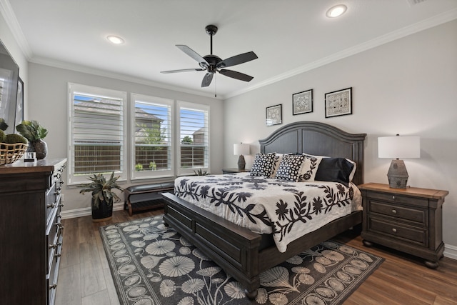 bedroom with ornamental molding, dark hardwood / wood-style floors, and ceiling fan