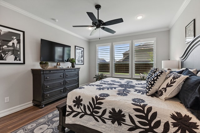 bedroom featuring dark hardwood / wood-style flooring, ceiling fan, and crown molding