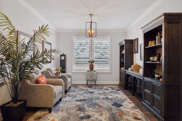 sitting room with a chandelier, ornamental molding, and dark wood-type flooring