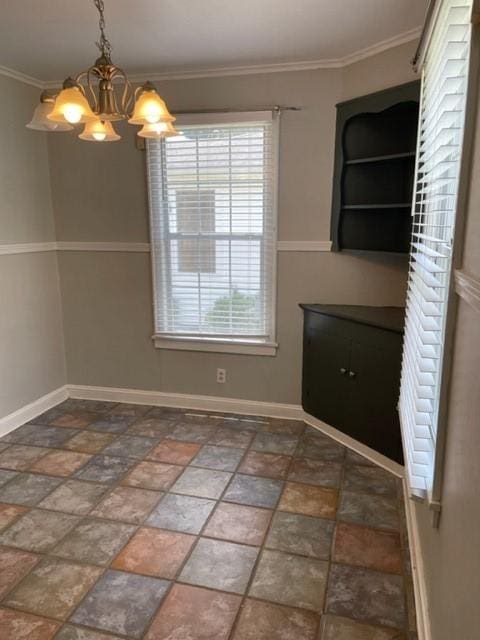 unfurnished dining area with a chandelier and ornamental molding