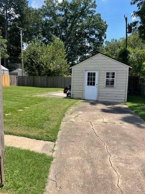 view of outbuilding featuring a yard