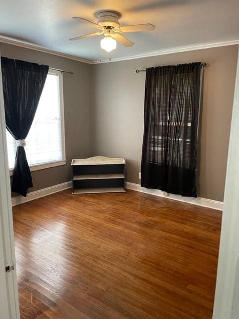 unfurnished bedroom featuring hardwood / wood-style flooring, ceiling fan, and ornamental molding