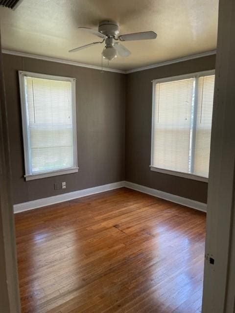 unfurnished room featuring ceiling fan, crown molding, and wood-type flooring