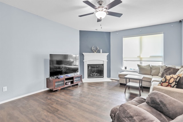 living room with ceiling fan and dark hardwood / wood-style flooring