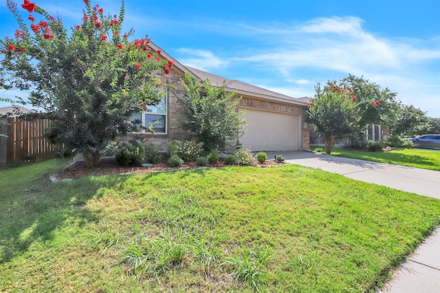 view of property hidden behind natural elements with a front lawn and a garage